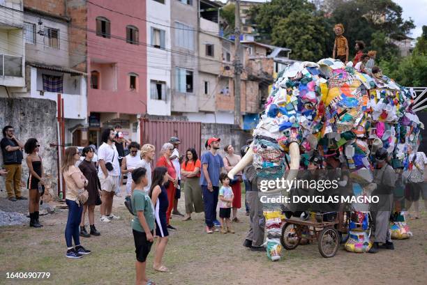 Members of the Pigmaliao Escultura Que Mexe group perform during a street show called "Elefanteatro" , which features a giant elephant puppet built...