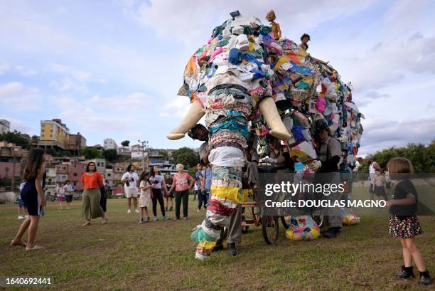 Members of the Pigmaliao Escultura Que Mexe group perform during a street show called "Elefanteatro" , which features a giant elephant puppet built...