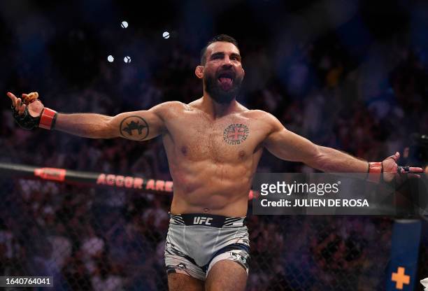 French mixed martial arts fighter Benoit Saint Denis celebrates after winning his fight against Brazilian mixed martial arts fighter Thiago Moises...