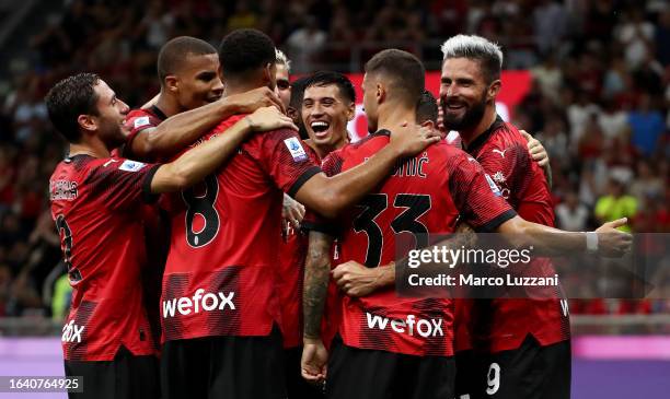 Olivier Giroud of AC Milan celebrates with teammates after scoring the team's fourth goal from a penalty kick during the Serie A TIM match between AC...