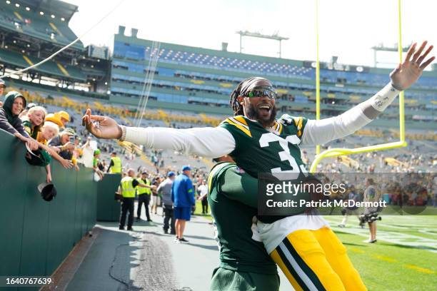 Dillon of the Green Bay Packers picks up Aaron Jones after defeating the Seattle Seahawks 19-15 during a preseason game at Lambeau Field on August...