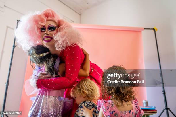 Children gather to hug Austin, Tx drag queen Brigitte Bandit after a drag time story hour at The Little Gay Shop fashion accessories store on August...