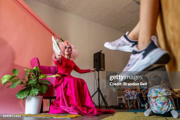 Austin, Tx drag queen Brigitte Bandit reads a book during a drag time story hour at The Little Gay Shop fashion accessories store on August 26, 2023...