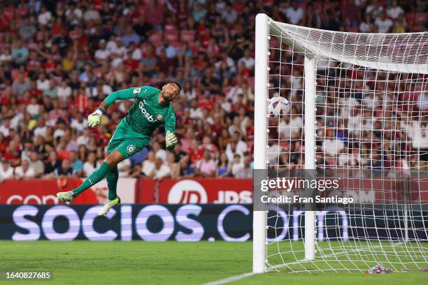 Paulo Gazzaniga of Girona fails to save a goal scored by Ivan Rakitic of Sevilla that was later disallowed during the LaLiga EA Sports match between...