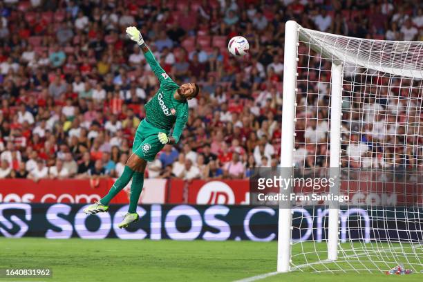 Paulo Gazzaniga of Girona fails to save a goal scored by Ivan Rakitic of Sevilla that was later disallowed during the LaLiga EA Sports match between...