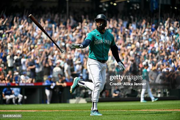 Teoscar Hernandez of the Seattle Mariners tosses his bat after hitting a grand slam home run during the third inning against the Kansas City Royals...