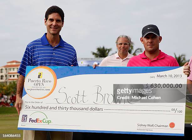 Scott Brown holds the winner's cheque during the trophy presentation after the final round of the Puerto Rico Open presented by seepuertorico.com...