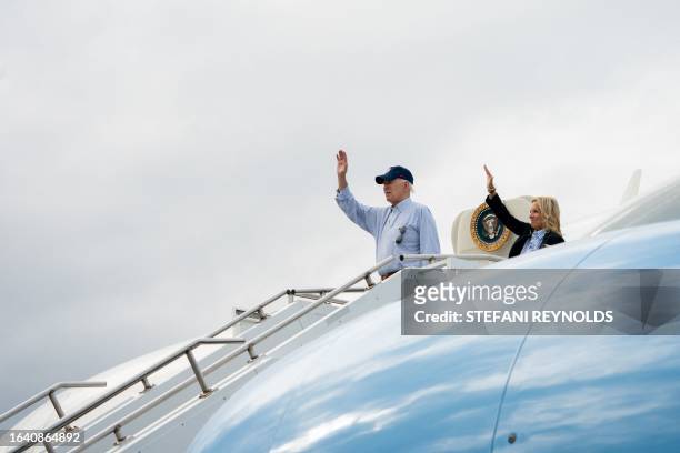President Joe Biden and First Lady Jill Biden wave as they board Air Force One before departing from Gainesville, Florida, on September 2, 2023. The...