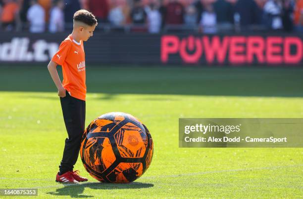 Young Blackpool fan plays with a giant football during the Sky Bet League One match between Blackpool and Wigan Athletic at Bloomfield Road on...