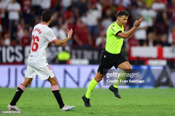 Referee, Jesus Gil gestures no to a penalty decision after a VAR review during the LaLiga EA Sports match between Sevilla FC and Girona FC at Estadio...