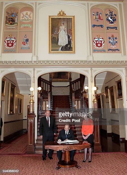 President of Myanmar, Thein Sein signs a visitors' book as Marie Bashir, Governor of New South Wales and her husband, Sir Nicholas Shehadie look on...