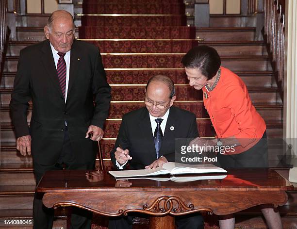 President of Myanmar, Thein Sein signs a visitors' book as Marie Bashir, Governor of New South Wales and her husband, Sir Nicholas Shehadie look on...
