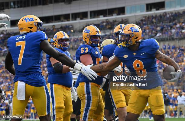 Karter Johnson of the Pittsburgh Panthers celebrates with Malcolm Epps after a 1-yard touchdown reception in the third quarter during the game...