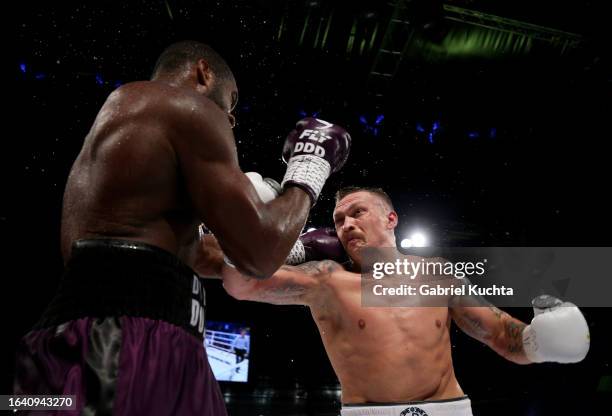 Oleksandr Usyk exchanges punches with Daniel Dubois during the Heavyweight fight between Oleksandr Usyk and Daniel Dubois at Stadion Wroclaw on...