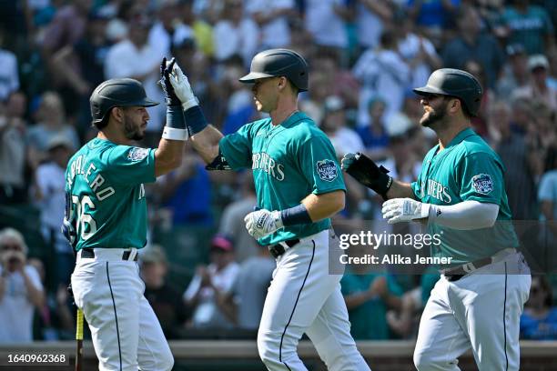 Dominic Canzone of the Seattle Mariners celebrates with teammates after hitting a two-run home run during the seventh inning against the Kansas City...