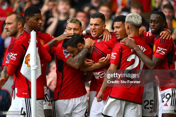 Manchester United player Bruno Fernandes celebrates with team mates after scoring the third United goal during the Premier League match between...