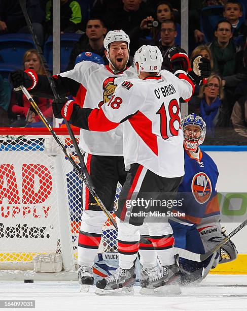 Jim O'Brien of the Ottawa Senators congratulates teammate Matt Kassian on his first period goal as goaltender Evgeni Nabokov of the New York...