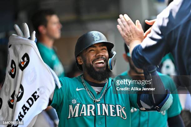 Teoscar Hernandez of the Seattle Mariners celebrates with teammates after hitting a solo home run during the eighth inning against the Kansas City...