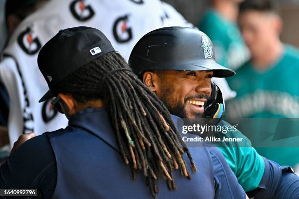 Teoscar Hernandez of the Seattle Mariners celebrates with teammates after hitting a solo home run during the eighth inning against the Kansas City...