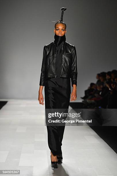 Model walks the runway wearing Sid Neigum fall 2013 collection during World MasterCard Fashion Week Fall 2013 at David Pecaut Square on March 19,...