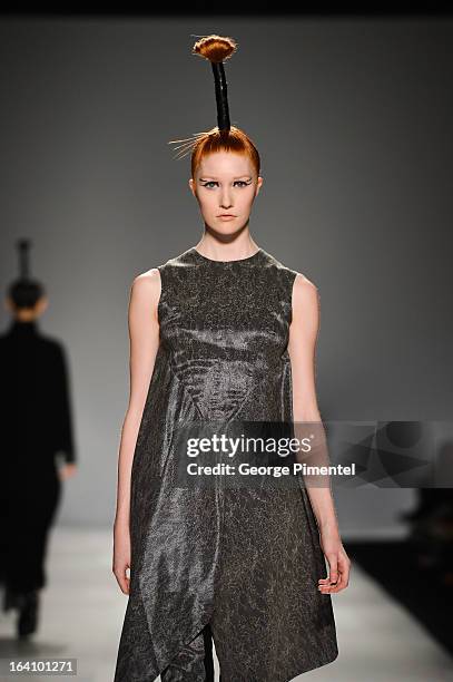 Model walks the runway wearing Sid Neigum fall 2013 collection during World MasterCard Fashion Week Fall 2013 at David Pecaut Square on March 19,...