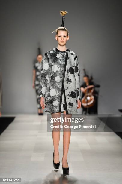 Model walks the runway wearing Sid Neigum fall 2013 collection during World MasterCard Fashion Week Fall 2013 at David Pecaut Square on March 19,...