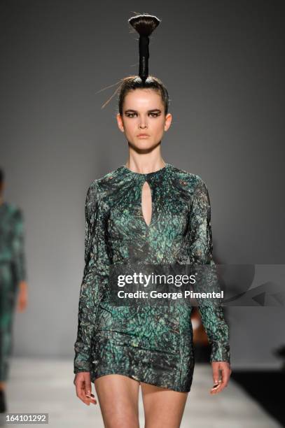 Model walks the runway wearing Sid Neigum fall 2013 collection during World MasterCard Fashion Week Fall 2013 at David Pecaut Square on March 19,...
