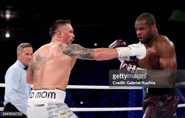Oleksandr Usyk punches Daniel Dubois during the Heavyweight fight between Oleksandr Usyk and Daniel Dubois at Stadion Wroclaw on August 26, 2023 in...