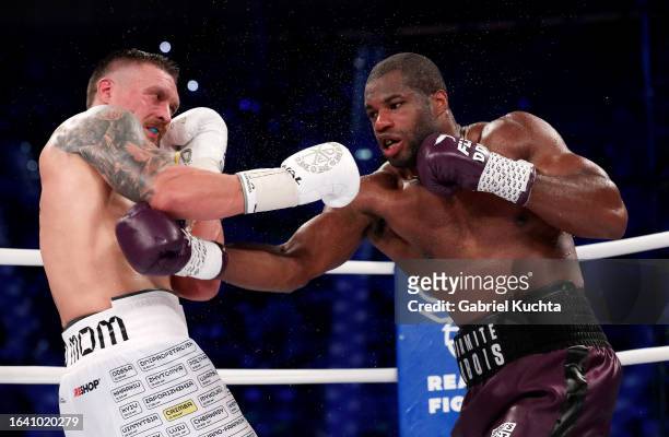 Oleksandr Usyk exchanges punches with Daniel Dubois during the Heavyweight fight between Oleksandr Usyk and Daniel Dubois at Stadion Wroclaw on...