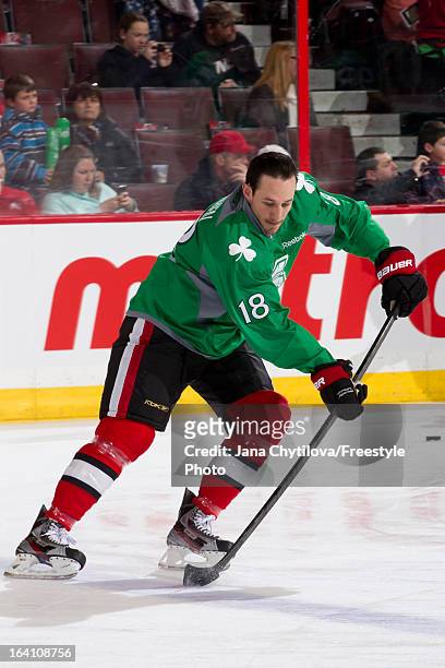 Jim O'Brien of the Ottawa Senators skates with the puck while wearing a green jersey to celebrate Saint Patrick's Day during warmups prior to an NHL...