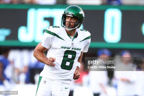 Aaron Rodgers of the New York Jets reacts after throwing a first quarter touchdown pass to Garrett Wilson in a preseason game against the New York...