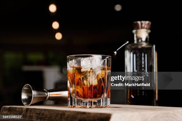 manhattan cocktail on the rocks - cherry drink stock pictures, royalty-free photos & images