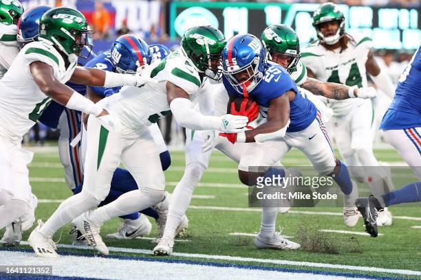 Jashaun Corbin of the New York Giants rushes the ball in for a second quarter touchdown against the New York Jets during a preseason game at MetLife...
