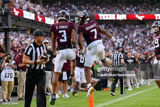 Texas A&M Aggies wide receiver Moose Muhammad III congratulates Texas A&M Aggies wide receiver Noah Thomas after his first half touchdown reception...