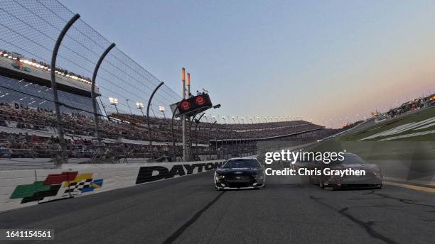 Chase Briscoe, driver of the Magical Vacation Planner Ford, and Aric Almirola, driver of the Smithfield Ford, lead the field on a pace lap prior to...