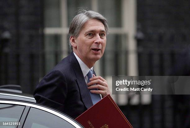 Defence Minister Philip Hammond leaves a cabinet meeting in Downing Street ahead of the Chancellor of the Exchequer, George Osborne presenting his...