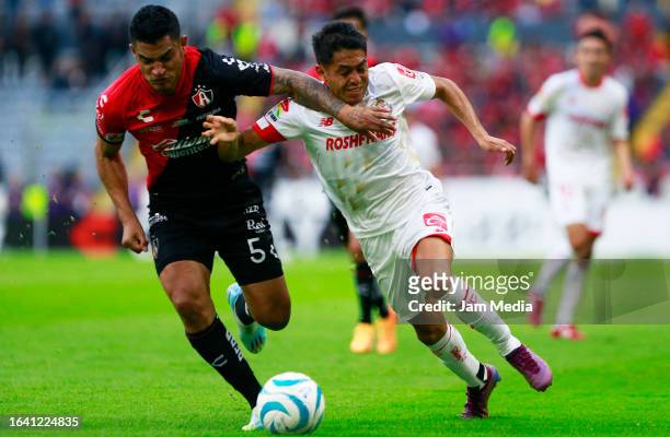 Anderson Santamaria of Atlas fights for the ball with Jean Meneses of Toluca during the 6th round match between Atlas v Toluca as part of Torneo...