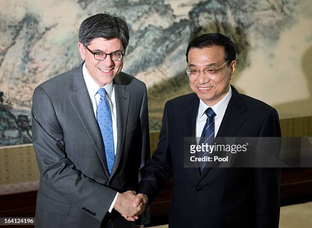 Treasury Secretary Jacob Lew, left, is greeted by Chinese Premier Li Keqiang upon his arrival at the Zhongnanhai diplomatic compound on March 20,...