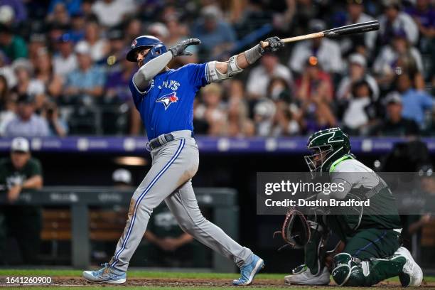 Whit Merrifield of the Toronto Blue Jays singles in the fifth inning against the Colorado Rockies at Coors Field on September 2, 2023 in Denver,...