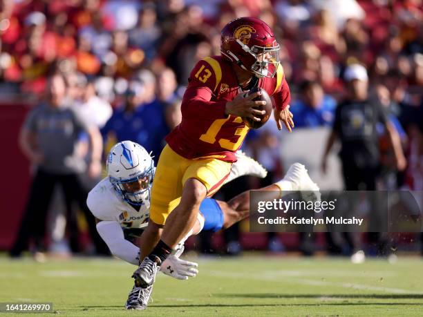 Caleb Williams of the USC Trojans avoids the tackle against Elijah Wood of the San Jose State Spartans during the second quarter at United Airlines...