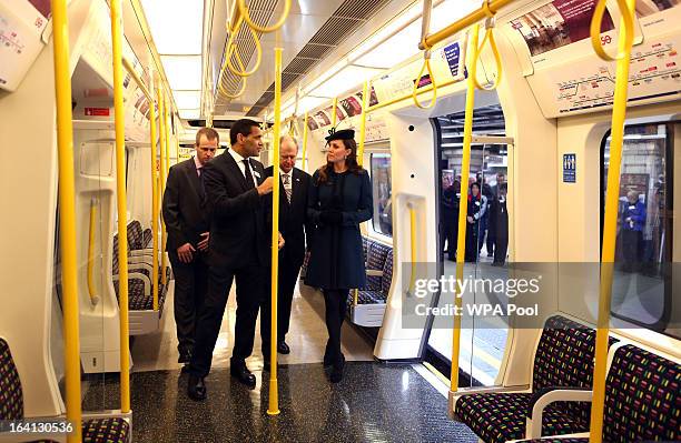 Catherine, Duchess of Cambridge stands onboard a train as she makes an official visit to Baker Street Underground Station, to mark 150th anniversary...