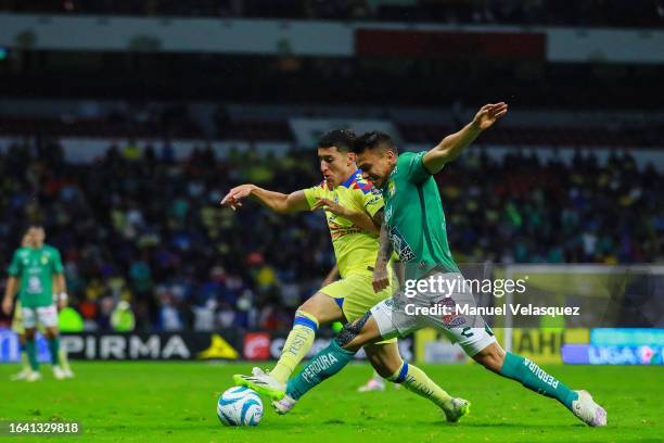 Alejandro Zendejas of America battles for the ball against Osvaldo Rodríguez of León during the 6th round match between America and Leon as part of...