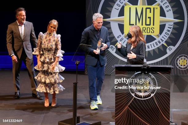 Steven Weber and Cheryl Hines present an award to Tim Daly and Robin Bronk onstage during the 10th Annual LMGI Awards Honoring Location Managers at...