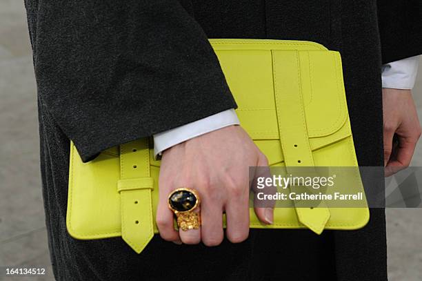 Hui He Final Year fashion student from China studying at LCF holding a Proenza Shouler citrus yellow clutch satchel and wearing rings by Yves St...