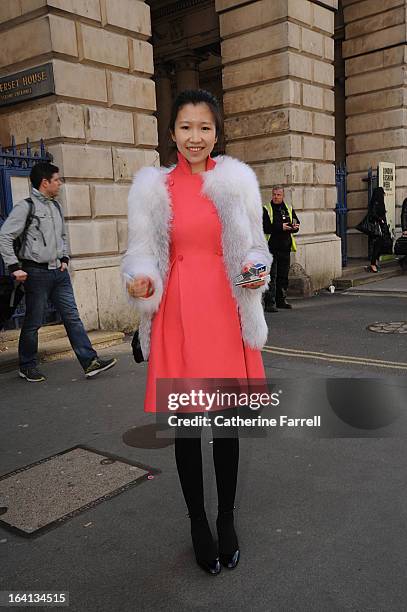 Elody Guo Assistant fashion editor from Chinese Vogue wearing fox fur coat made to order in Beijing, with salmon pink coat by Valentino, accessorised...