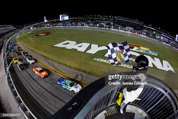 Chris Buescher, driver of the Fifth Third Bank Ford, takes the checkered flag to win the NASCAR Cup Series Coke Zero Sugar 400 at Daytona...