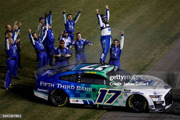 Chris Buescher, driver of the Fifth Third Bank Ford, and crew celebrate after winning the NASCAR Cup Series Coke Zero Sugar 400 at Daytona...