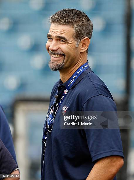 Former infielder Mike Lowell of the Boston Red Sox smiles during batting practice just before the Grapefruit League Spring Training Game against the...