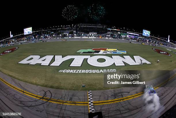 Chris Buescher, driver of the Fifth Third Bank Ford, celebrates with a burnout after winning the NASCAR Cup Series Coke Zero Sugar 400 at Daytona...