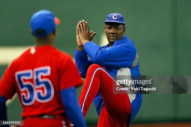 Pitching coach Juan de Dios Pena of Team Cuba demonstrates a pitching drill during the 2013 World Baseball Classic workout day at the Tokyo Dome on...